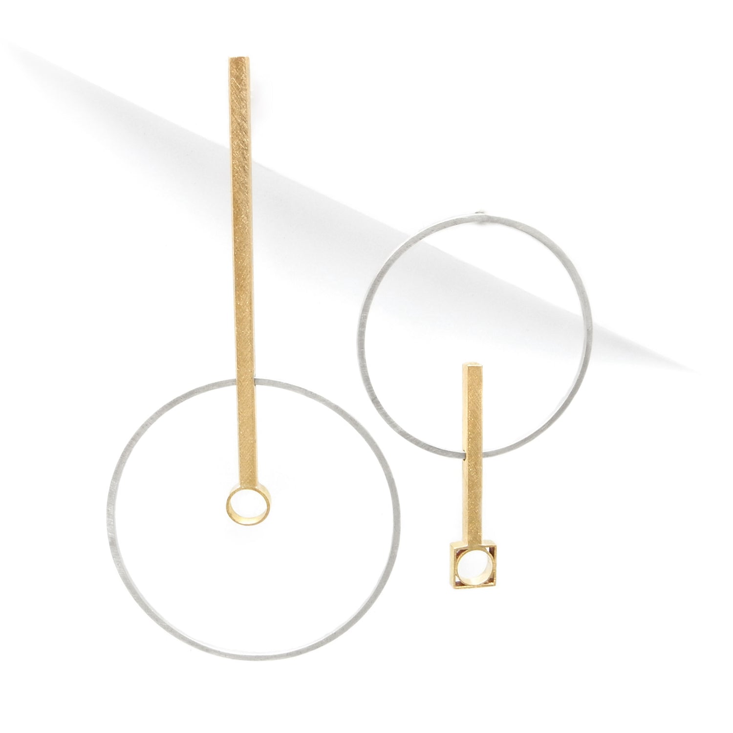 mismatched earrings in gold and silver