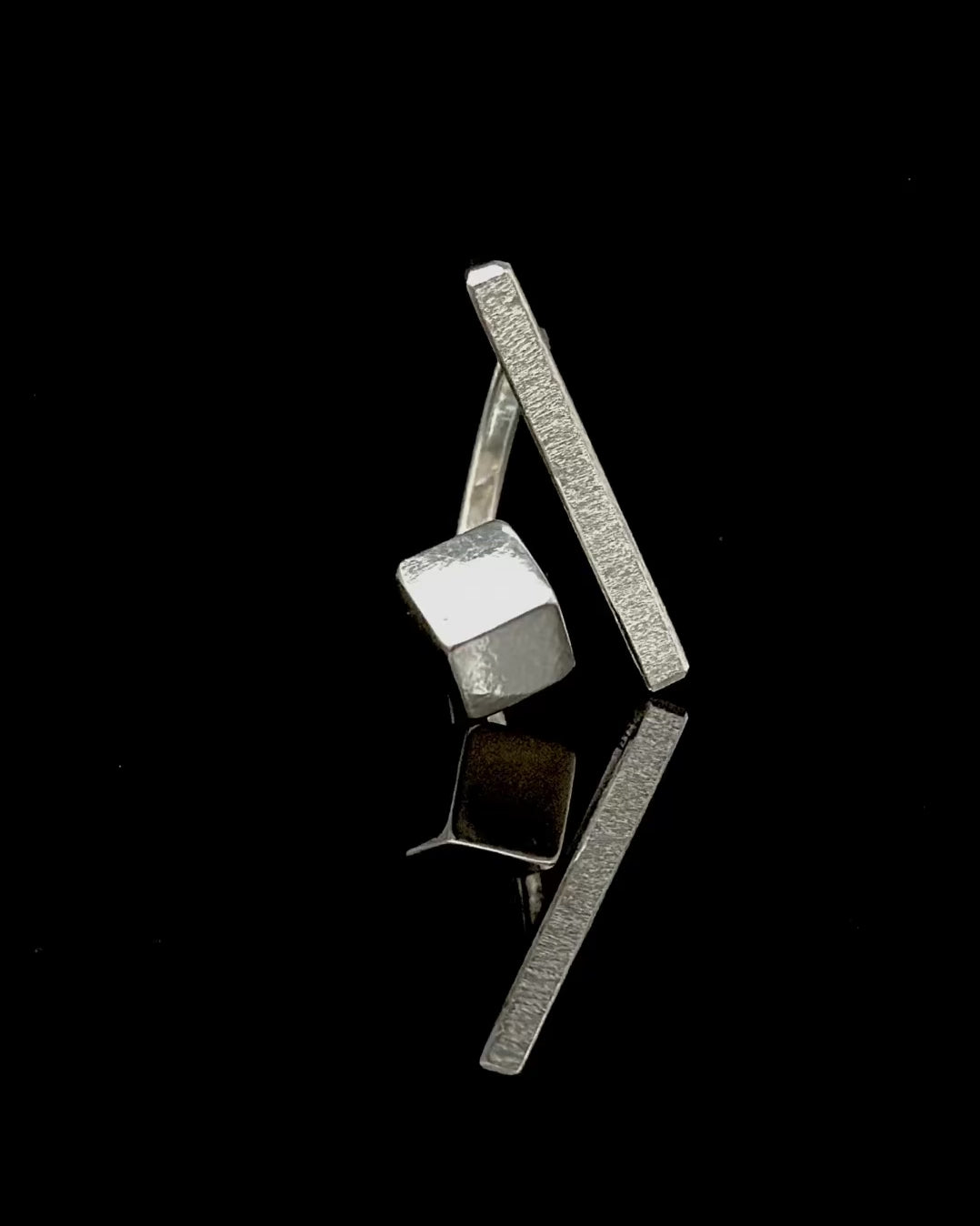 Spinning statement ring with cube and stick. 