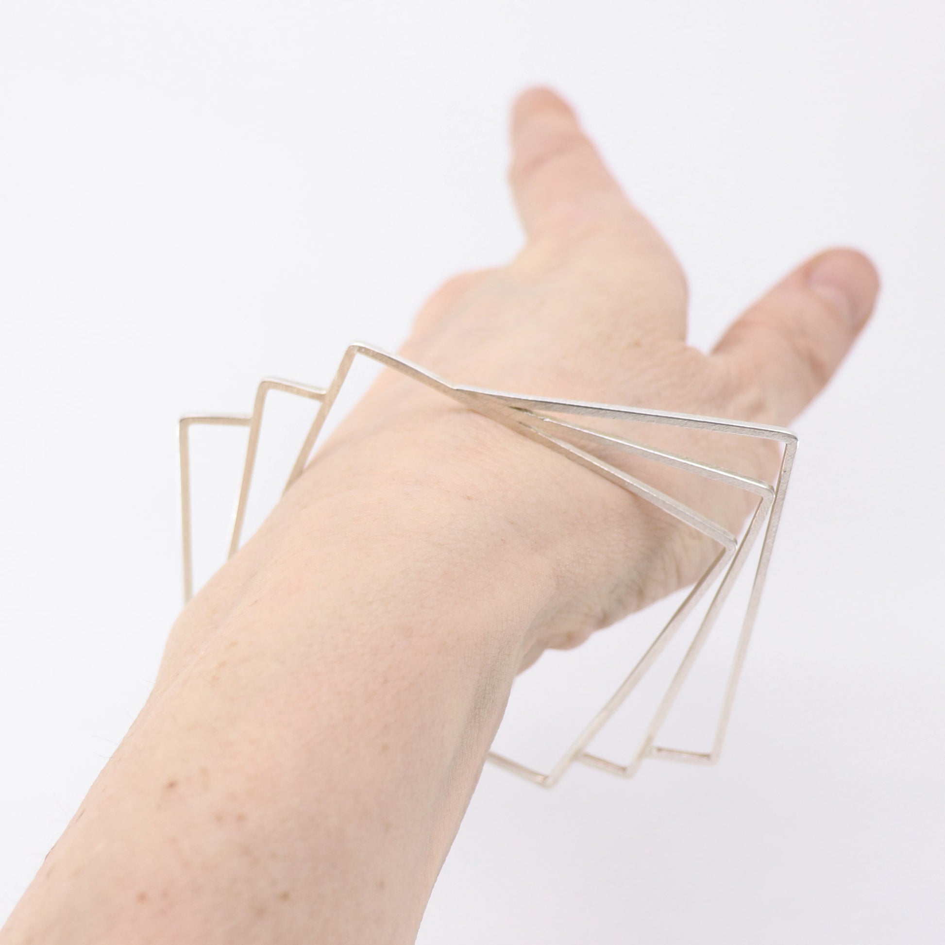 geometric silver handmade bangle modelled on wrist