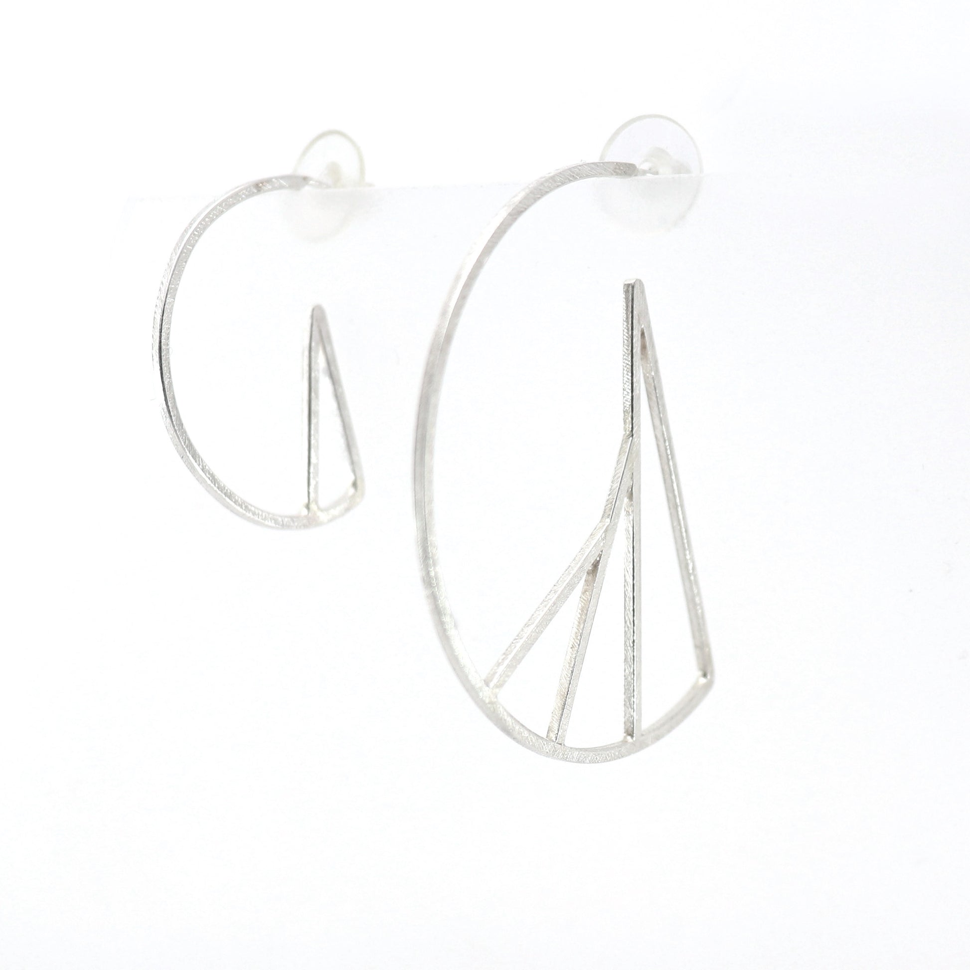 Silver hoop earrings with vertical bars on a white background