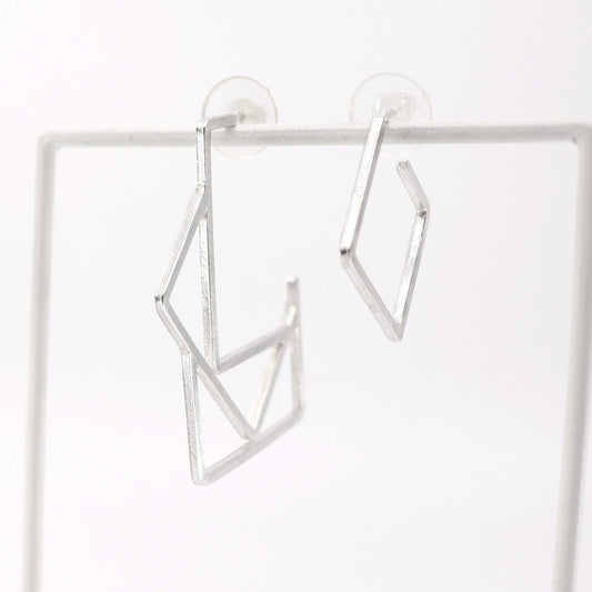 Silver geometric hoop earrings on a white background